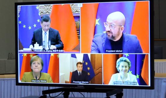 European Commission President Ursula von der Leyen, European Council President Charles Michel, German Chancellor Angela Merkel, French President Emmanuel Macron and Chinese President Xi Jinping are seen on a screen during a video conference to approve an investment pact between China and the European Union on December 30, 2020 in Brussels, Belgium. (Photo by Dursun Aydemir/Anadolu Agency via Getty Images)