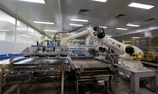 A robot moves bags of non-polyvinyl chloride (PVC) intravenous (IV) solutions on a production line at the JW Life Science Corp. factory in Dangjin, South Korea, on Thursday, March 2, 2017. 